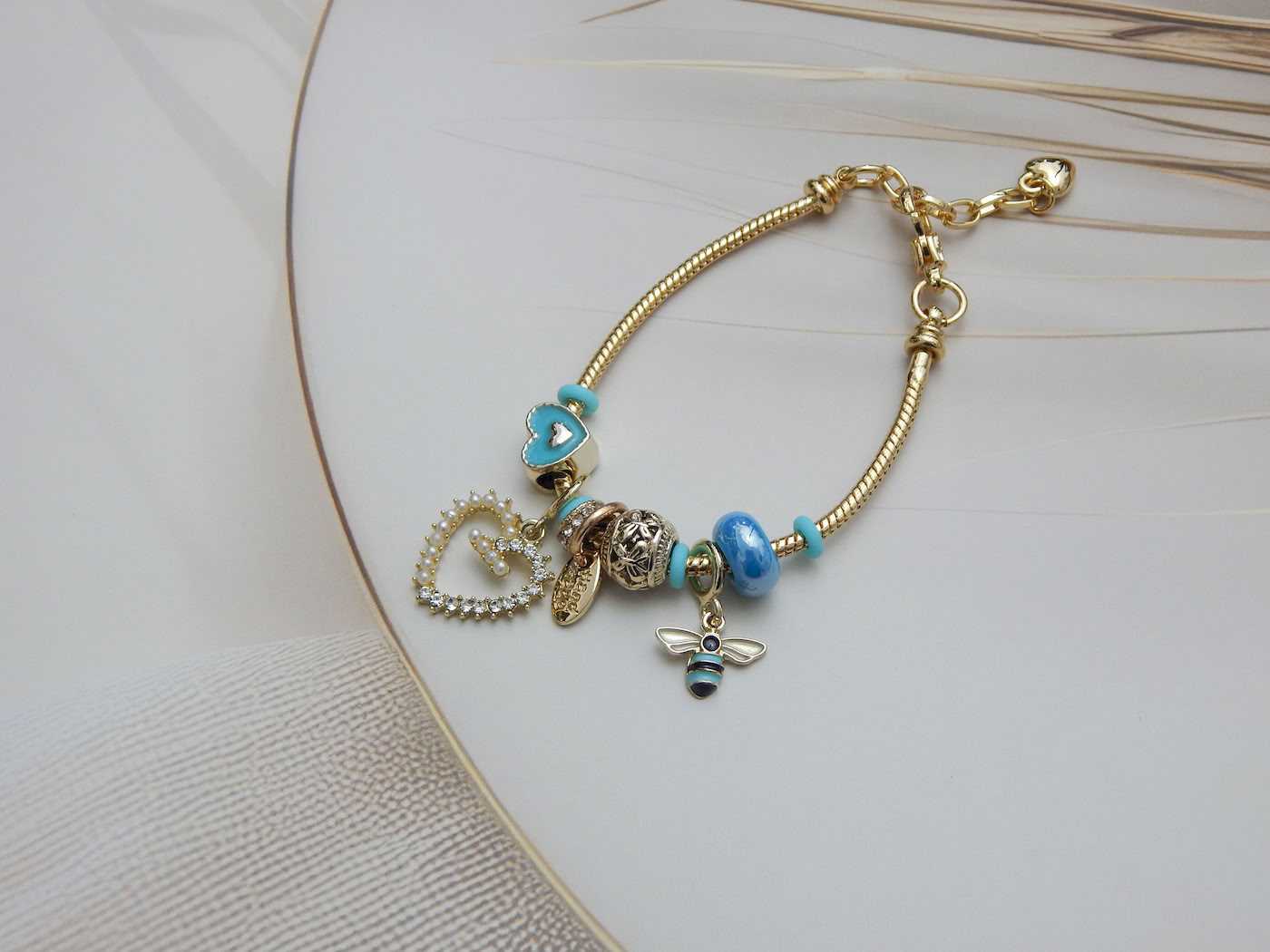 Blue Heart & Bee Charm Bracelet with enamel heart, bee pendant and aqua bead charms on adjustable gold snake chain