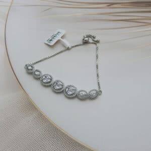 Illusion cluster bracelet in silver finish — seven oval halo stations with mixed stone clusters on box chain
