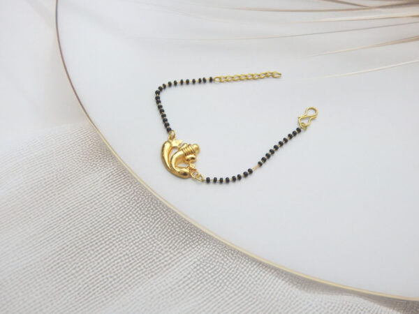 Gold Ganesha charm bracelet with black beads