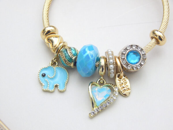 Gold charm bracelet with blue enamel elephant and heart charm