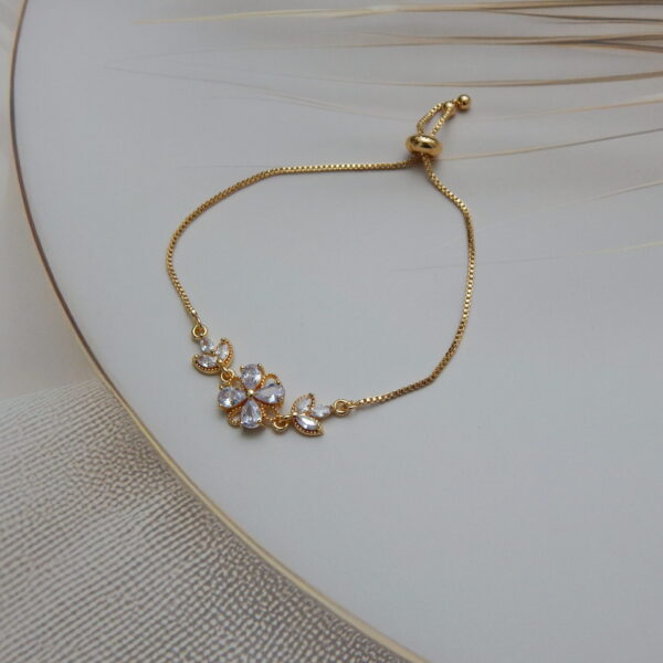 Gold-toned bracelet with white crystal floral design for women