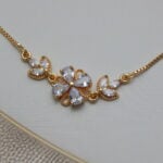 Gold-toned bracelet with white crystal floral design for women