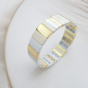Square tile stretch bracelet in cream and gold tones with gold‑trim