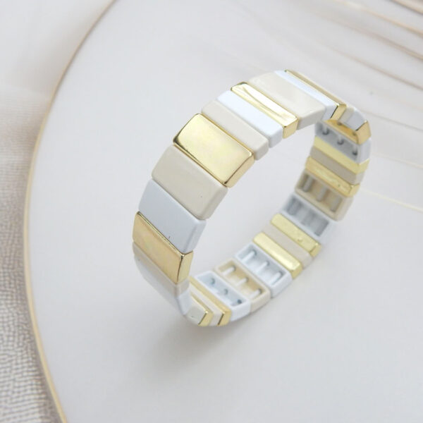 Square tile stretch bracelet in cream and gold tones with gold‑trim