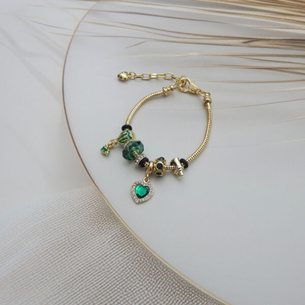 Bracelet featuring a green heart charm, glass balloon bead, Murano-style beads, and snake chain