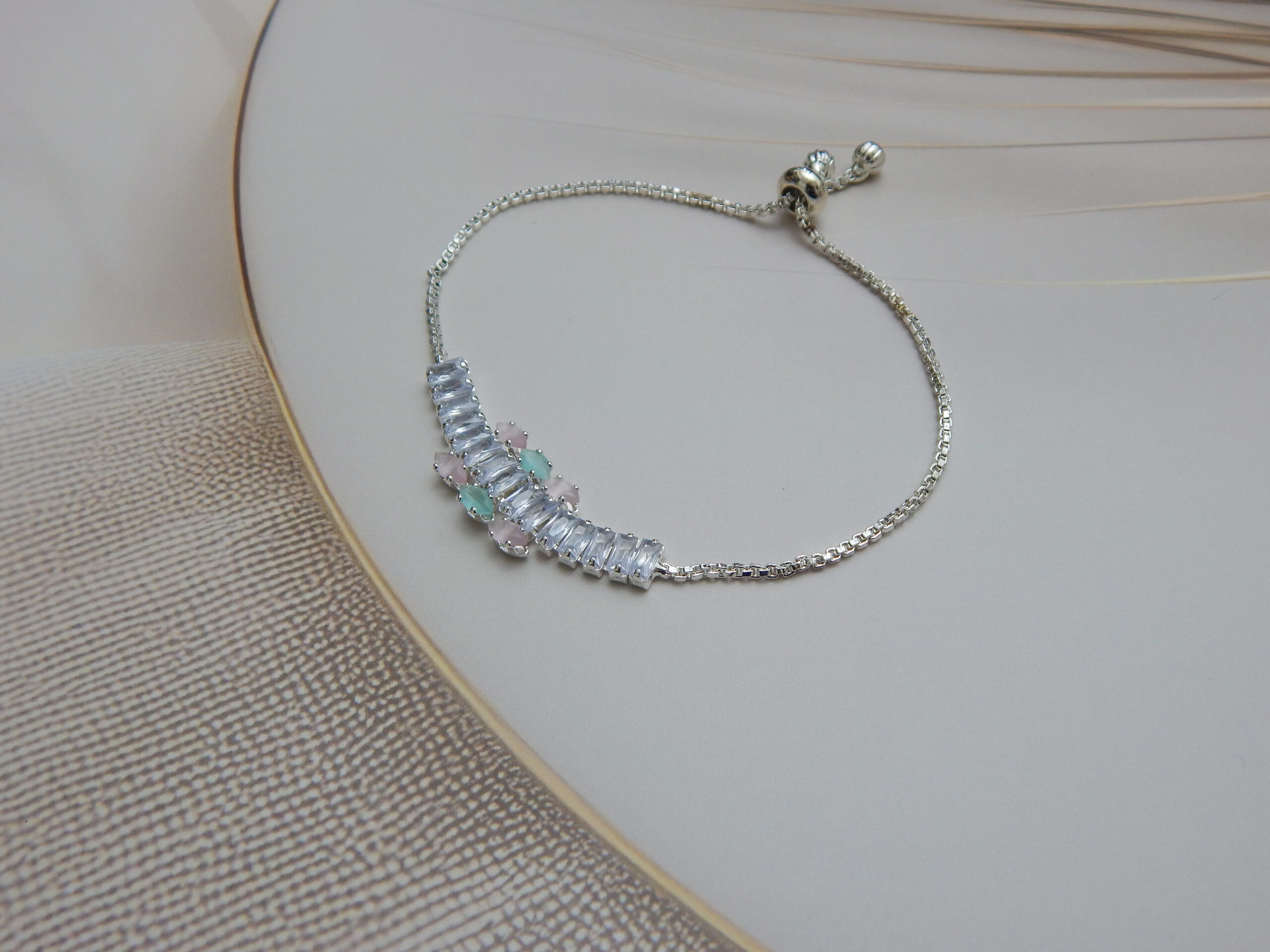 Rose gold bracelet with mint green center flower and baguette stones