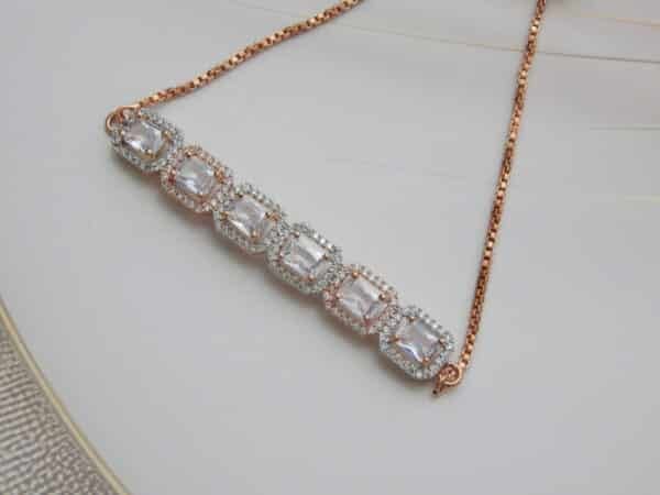 Rectangular halo bracelet in rose gold finish zoomed — six large faceted stones in bold rectangular halos on box chain
