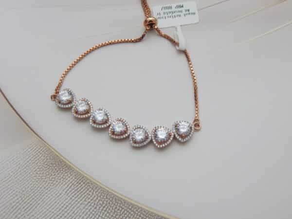 American diamond halo bracelet in rose gold finish — seven graduating heart halo stones on box chain