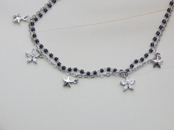 Silver dual chain bracelet with black beads, star and flower charms
