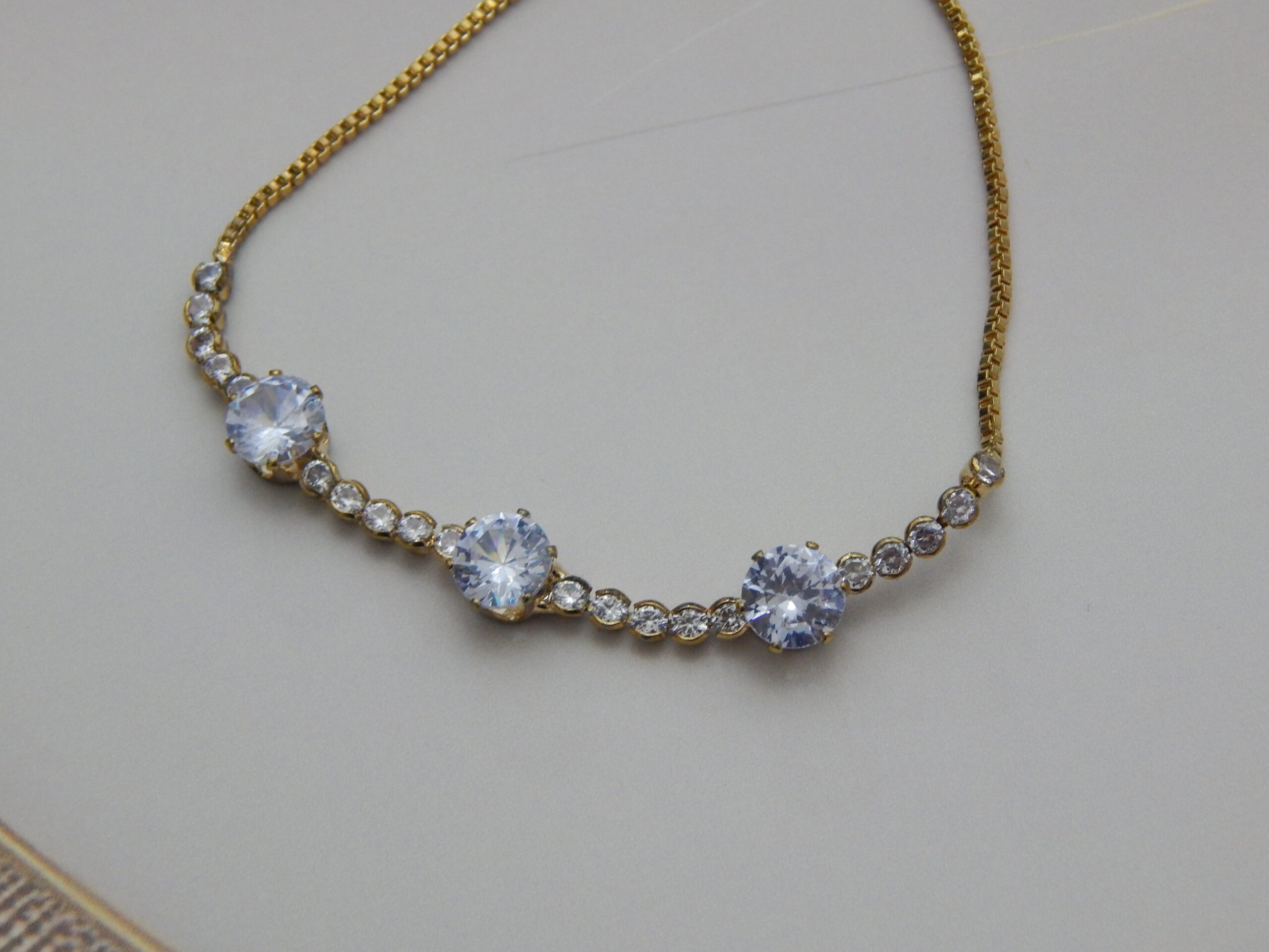 gold-plated triple crystal bracelet with round-cut stones