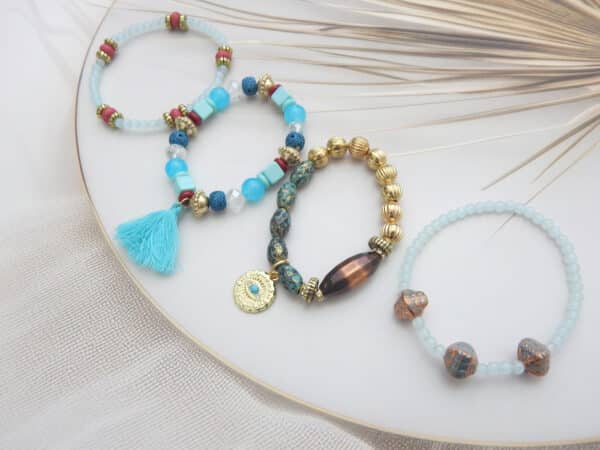 Aqua and tribal-style bracelet set with tassel, gold accents, and coin charm – 4-piece beaded combo under ₹299