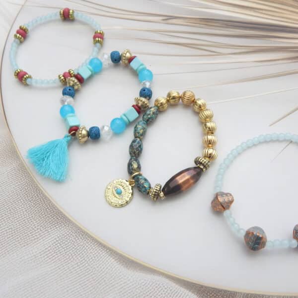 Aqua and tribal-style bracelet set with tassel, gold accents, and coin charm – 4-piece beaded combo under ₹299