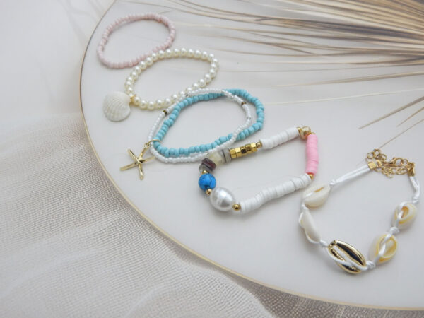 Set of 5 pastel and white beach-inspired bracelets with shell, pearl, starfish, and cowrie charms – Royal Reflection