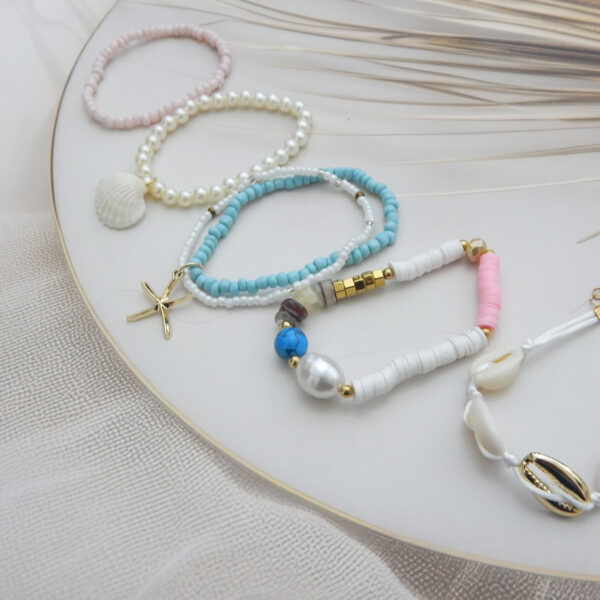 Set of 5 pastel and white beach-inspired bracelets with shell, pearl, starfish, and cowrie charms – Royal Reflection