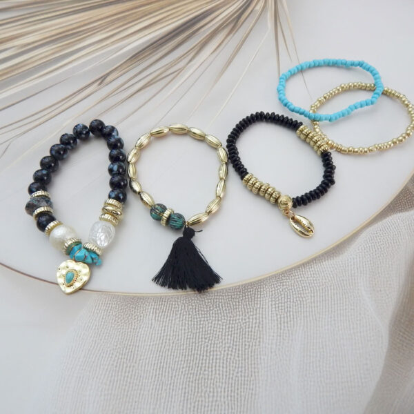 Set of 5 black, turquoise, and gold beaded charm bracelets with heart, shell, and tassel accents – Royal Reflection DS