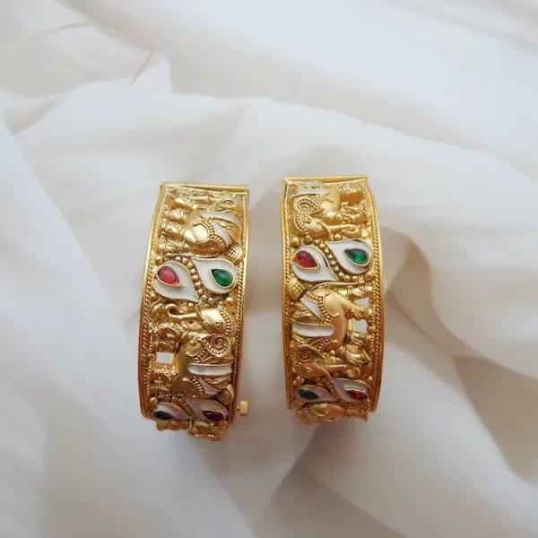 Elephant motif kada in antique gold plating with red, green, and white teardrop stones