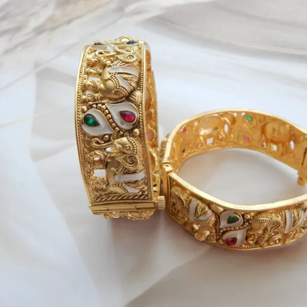 Elephant motif kada in antique gold plating with red, green, and white teardrop stones