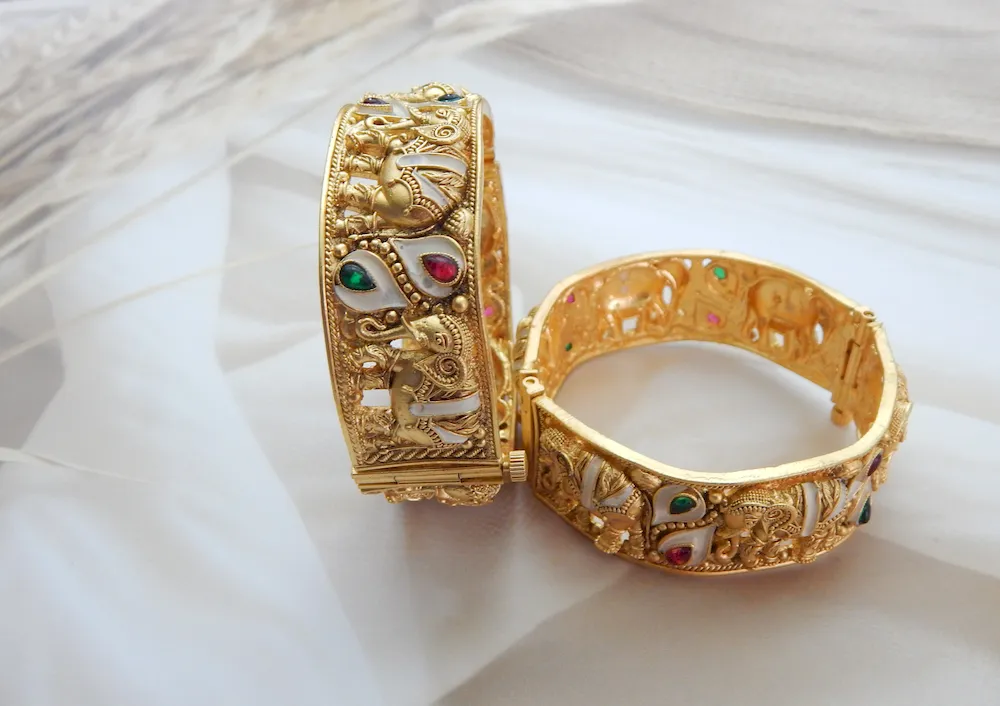 Elephant motif kada in antique gold plating with red, green, and white teardrop stones