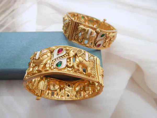 Elephant motif kada in antique gold plating with red, green, and white teardrop stones