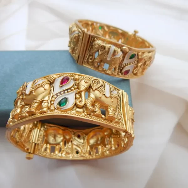 Elephant motif kada in antique gold plating with red, green, and white teardrop stones