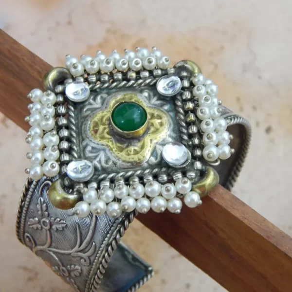 Antique silver-plated filigree cuff bracelet with pearl border and green center stone