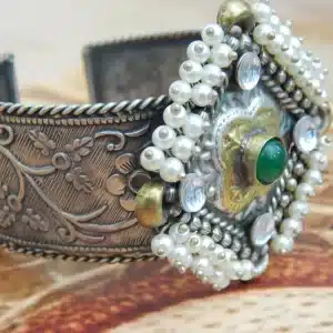 Antique silver-plated filigree cuff bracelet with pearl border and green center stone