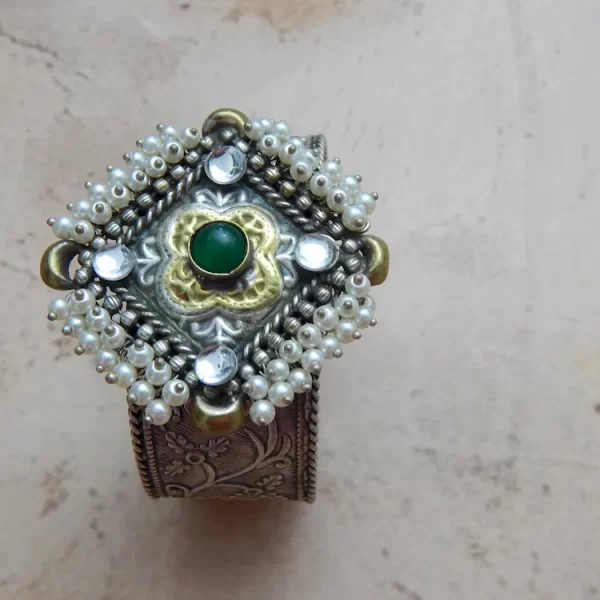 Antique silver-plated filigree cuff bracelet with pearl border and green center stone