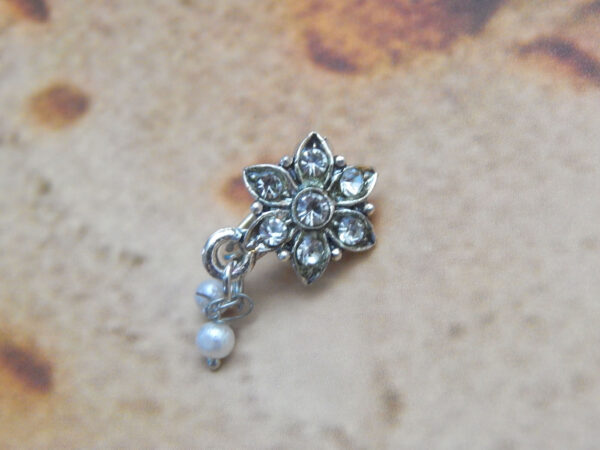 Silver floral nath with six crystal petals and hanging dual pearls on textured background