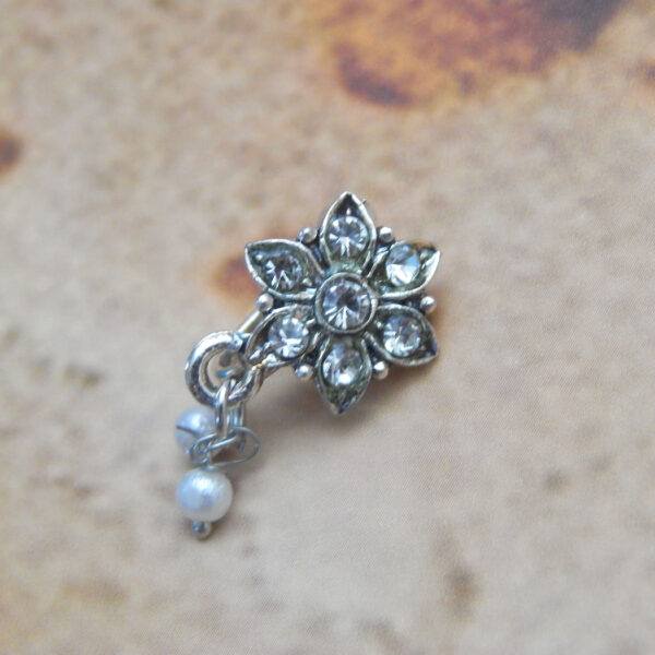Silver floral nath with six crystal petals and hanging dual pearls on textured background