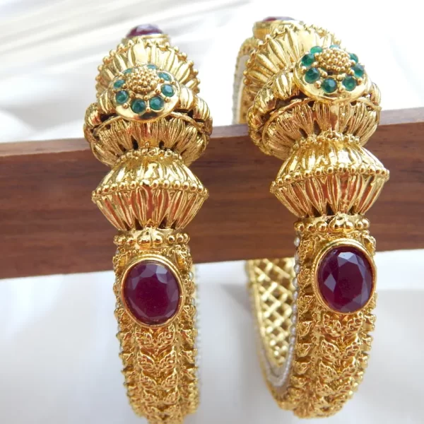 Antique gold-plated kada set with elephant and gemstone motifs on white background