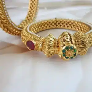 Antique gold-plated kada set with elephant and gemstone motifs on white background