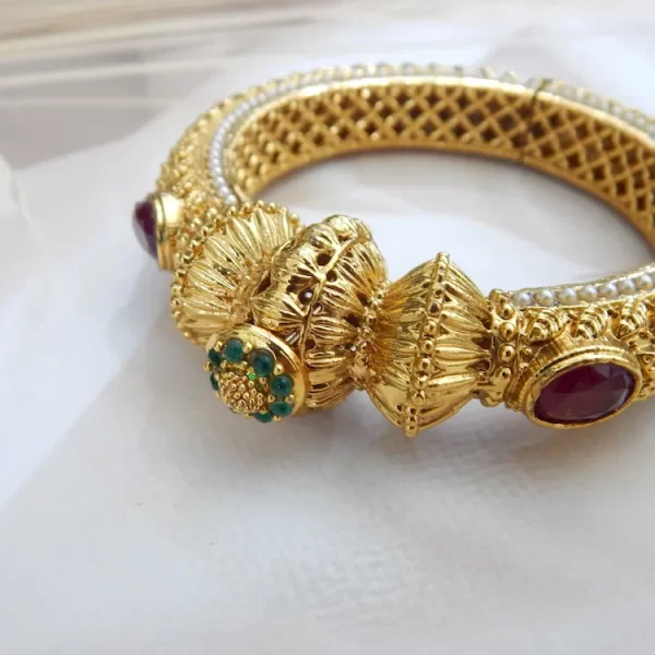 Antique gold-plated kada set with elephant and gemstone motifs on white background