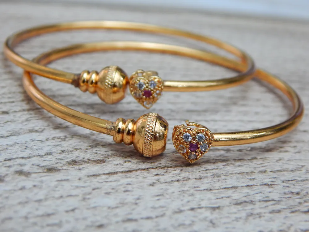 Gold-plated kada with heart-shaped stone charm and sparkling accents