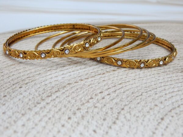 Antique Gold-Toned Bangles with Engraved Motifs and Stone Accents – Royal Reflection DS