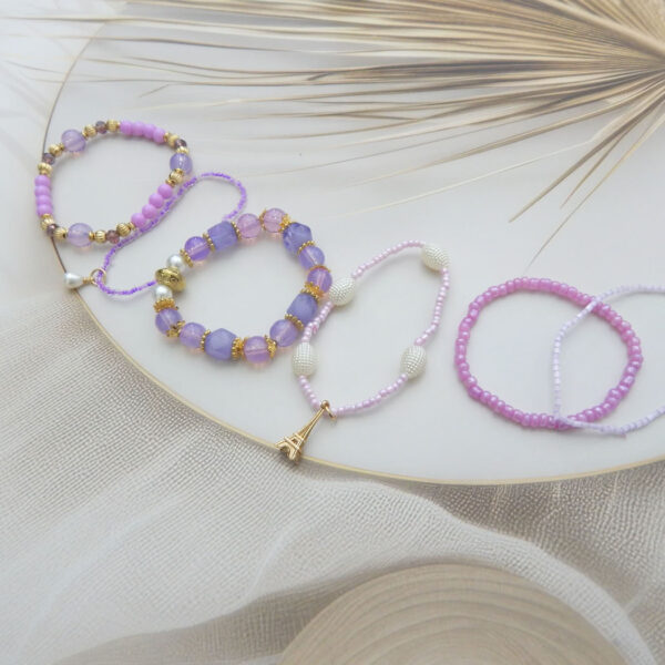 Lavender and pink bracelet set with Eiffel Tower and pearl charms – set of 5 stylish beaded bracelets under ₹299