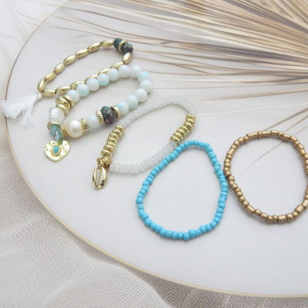 Bracelet set with gold, blue, and white beads featuring shell, tassel, and heart charms – stylish 5-piece ocean-inspired set under ₹299