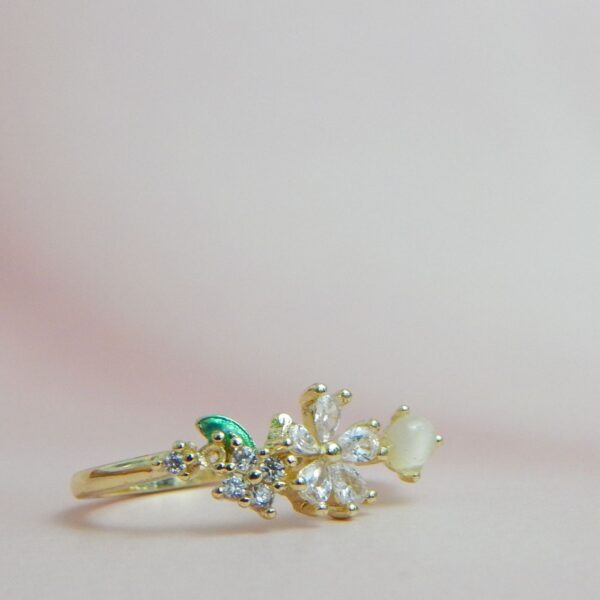 Pearl Bloom Adjustable Gold-Tone Ring with Crystal Flower and Green Leaf Accent – Royal Reflection DS