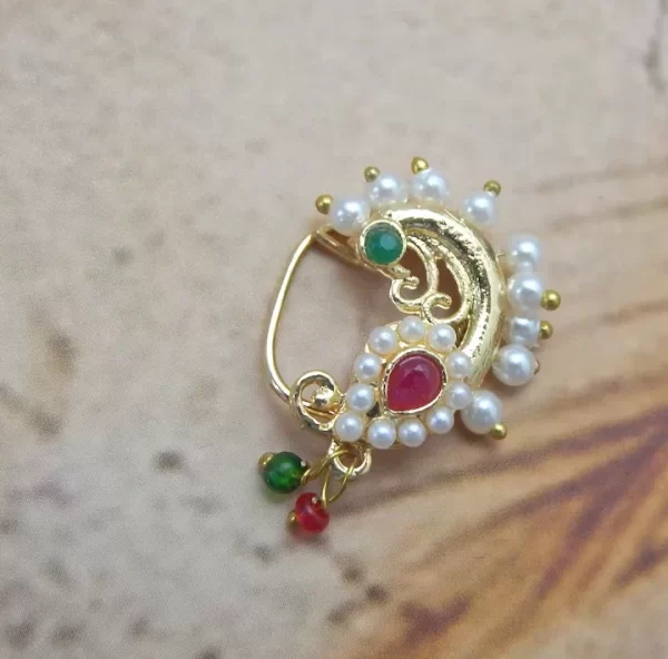 Golden swirl Nath with red centerpiece, pearl outline, and green-red beads under ₹70