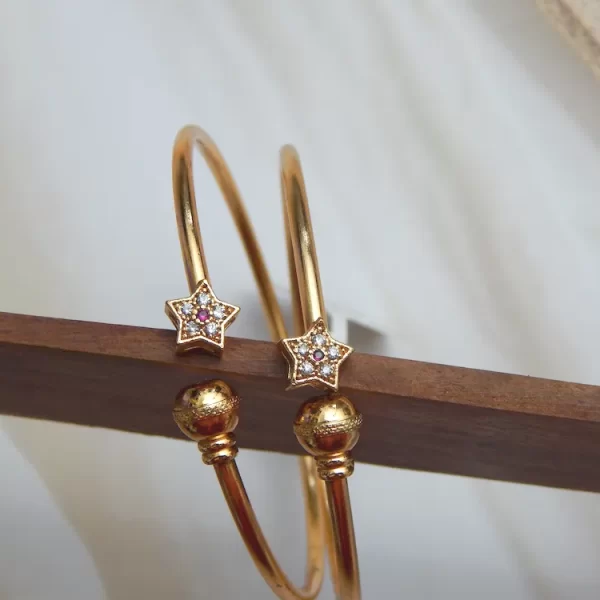 Starburst gold kada with twin star crystal charms and textured ball caps – affordable festive jewellery at ₹160