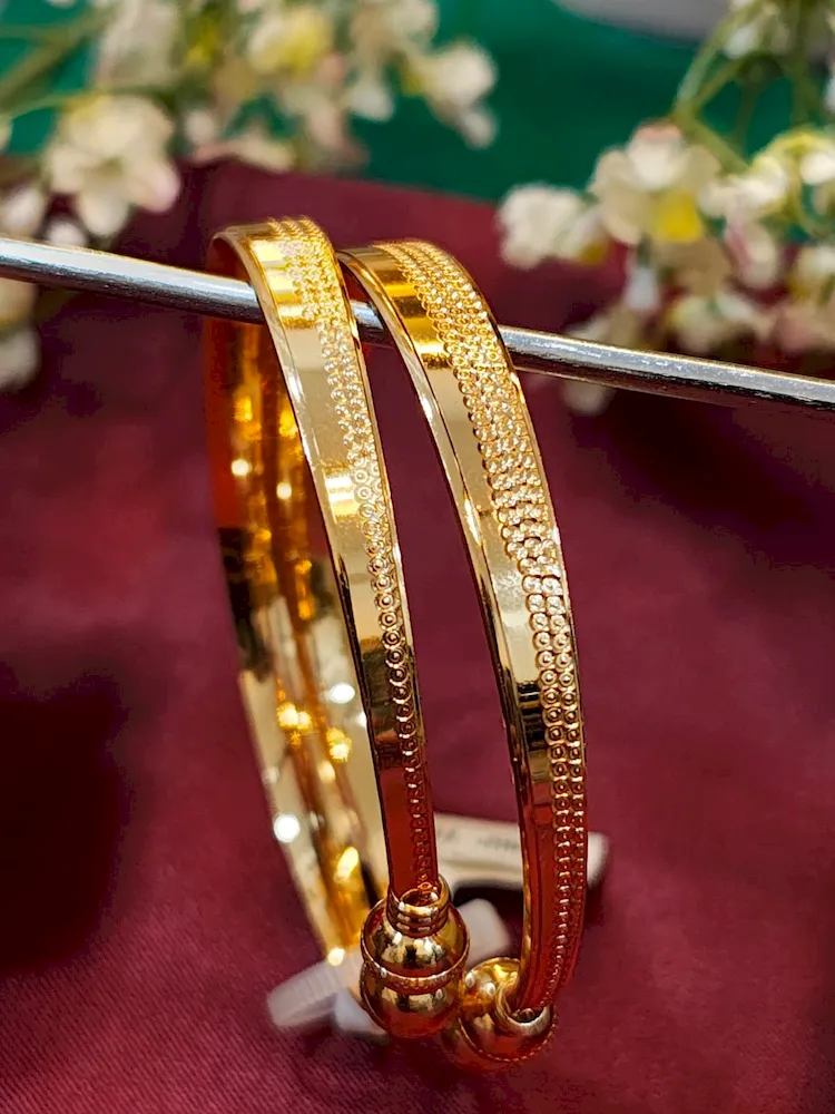 Symphonic gold kada with glossy finish and twin ball detailing – imitation jewellery for ₹220