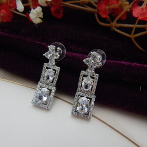 A stylish geometric necklace and earring set with alternating oval and square designs in a modern, silver-toned finish.