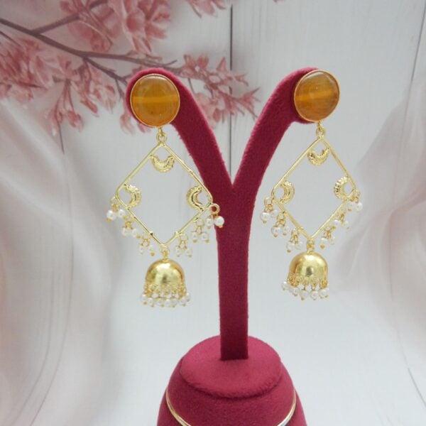 Navratri Orange Jewellery - Royal Reflection DS Geometric jhumka earrings with orange stone stud, open square frame and pearl drops on a stand
