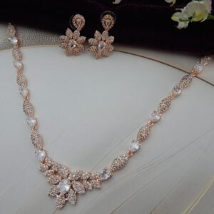 Close-up of Gul Bahar designer floral necklace and earring set in a rose gold finish with an intricate floral design