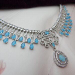 Turquoise blue american diamond fringe necklace with cascading teardrop drops and scrollwork centre
