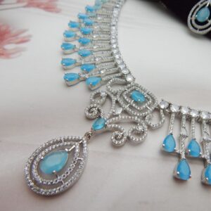 Turquoise blue teardrop pendant with double CZ halo and scrollwork on Jeevan fringe necklace