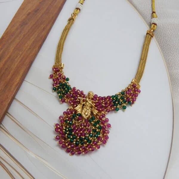Krishna Motif Necklace Set with Ruby-Green Pearl Drops and Gold Polish – Royal Reflection DS