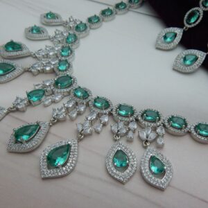 Close-up of the Noorjahan statement necklace and earring set featuring a cascade of green pendants and a silver finish.