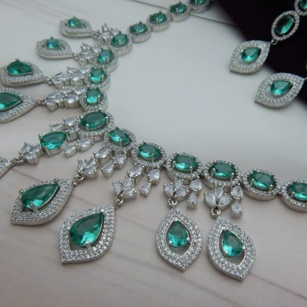 Navratri Green Jewellery - Royal Reflection DS Close-up of the Noorjahan statement necklace and earring set featuring a cascade of green pendants and a silver finish.