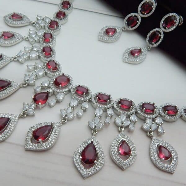 Navratri Red Jewellery - Royal Reflection DS Close-up of the Noorjahan Statement Drop Necklace Set in maroon featuring a cascade of red pendants and a silver finish.