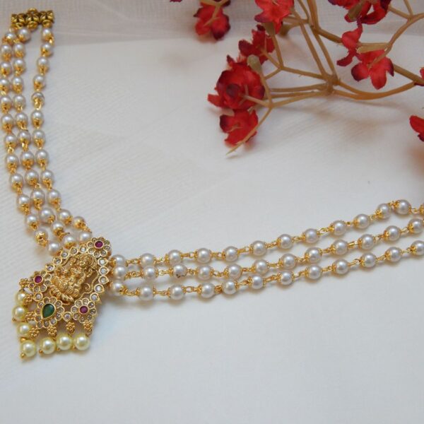 A traditional three-strand pearl necklace only